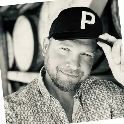 A black and white photo of Todd Pritts wearing a hat.