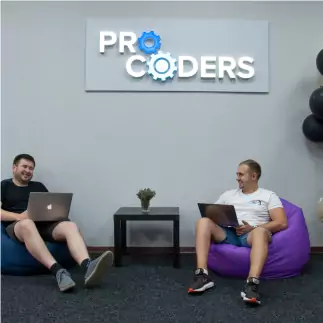 Two developers sitting in chairs and laughing