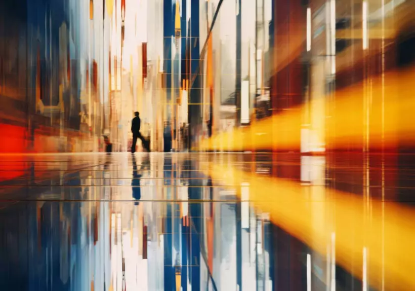 Blurred image of a person walking down a hallway